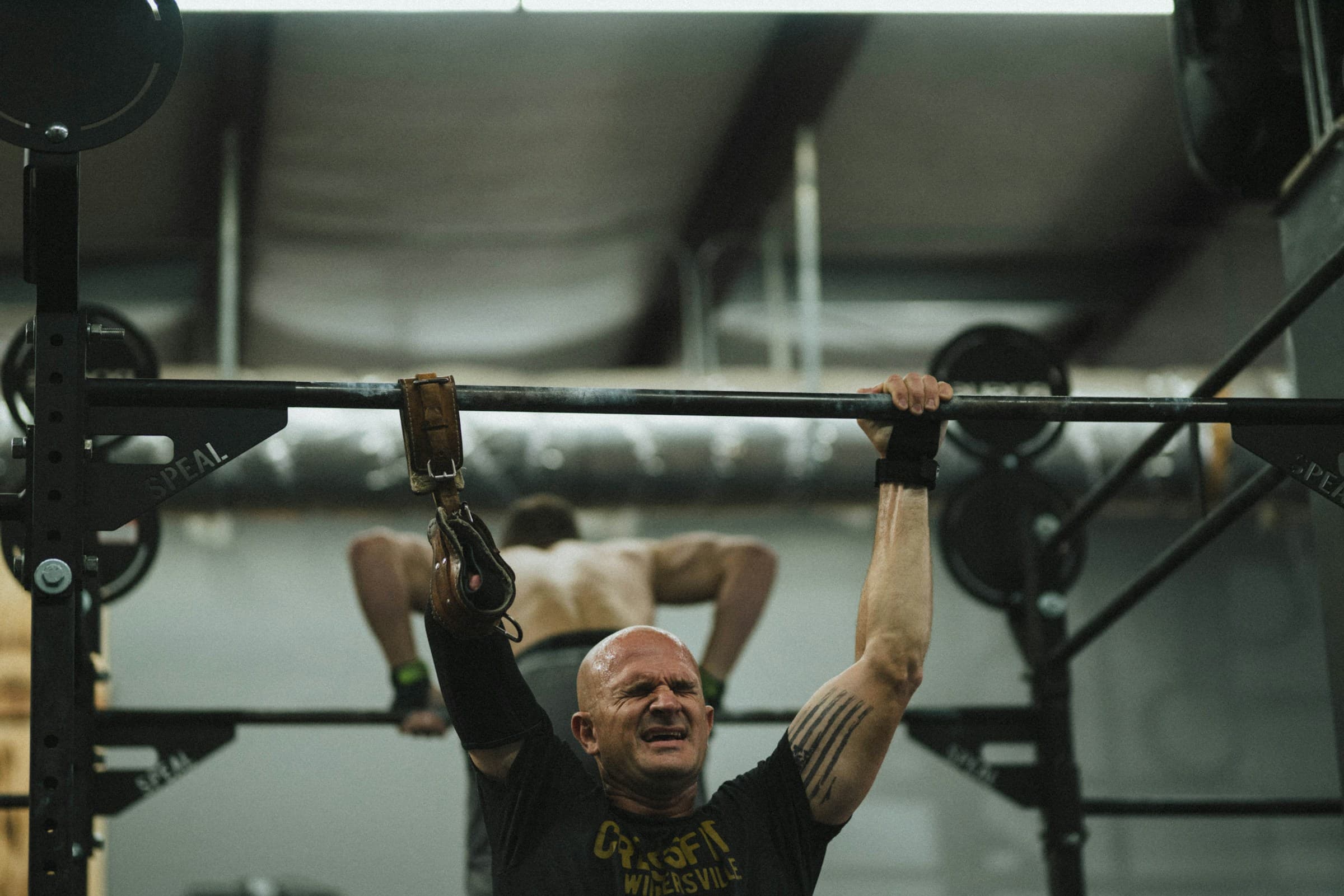 A veteran training in a gym with adaptive equipment.